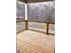Covered back deck with wooden railing and a view of wooded backyard at 4863 Amsler Rd, Ellenwood, GA 30294