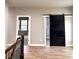 Upstairs hallway with hardwood flooring and a black sliding barn door at 4863 Amsler Rd, Ellenwood, GA 30294