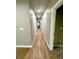 A well-lit hallway with wood-look flooring connects the bedrooms to the rest of the house at 4863 Amsler Rd, Ellenwood, GA 30294