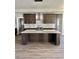 Modern kitchen with large island, stainless steel appliances, and stylish countertops at 4863 Amsler Rd, Ellenwood, GA 30294