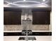 Close up of a kitchen with stainless steel range hood and modern backsplash at 4863 Amsler Rd, Ellenwood, GA 30294
