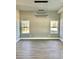 Bright living room features stylish lighting, wood floors and natural light through two windows at 4863 Amsler Rd, Ellenwood, GA 30294