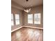 Living room with many windows offering ample natural light and wooded backyard views at 4863 Amsler Rd, Ellenwood, GA 30294