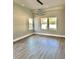 Bright living room features stylish lighting, wood floors and natural light through three windows at 4863 Amsler Rd, Ellenwood, GA 30294