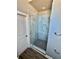 A modern glass enclosed shower features gray marble tiling and matte black mosaic tiling at 4863 Amsler Rd, Ellenwood, GA 30294