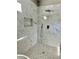 Shower features beautiful marble walls, rain shower head, handheld sprayer and inlaid design on the floor at 4863 Amsler Rd, Ellenwood, GA 30294