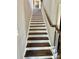 A staircase with recessed lighting lining the steps creates a safe and modern design at 4863 Amsler Rd, Ellenwood, GA 30294