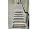 A staircase with recessed lighting lining the steps creates a safe and modern design at 4863 Amsler Rd, Ellenwood, GA 30294