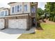 Beautiful townhome with brick facade, two-car garage and manicured lawn at 1442 Casteel Lake Ln # 277, Buford, GA 30518