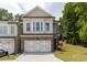 Charming two-story townhome with brick facade, two-car garage and well-manicured lawn at 1442 Casteel Lake Ln # 277, Buford, GA 30518