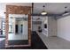Modern fitness center with cardio equipment, mirrors, and exposed brick accents at 1442 Casteel Lake Ln # 277, Buford, GA 30518