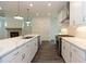 Modern kitchen with white cabinets, quartz countertops and island at 1442 Casteel Lake Ln # 277, Buford, GA 30518