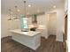 Modern kitchen with white cabinets, quartz countertops and island at 1442 Casteel Lake Ln # 277, Buford, GA 30518