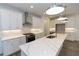 Bright white kitchen with stainless steel appliances, marble counters, and pendant lighting at 1442 Casteel Lake Ln # 277, Buford, GA 30518
