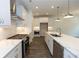 Modern kitchen featuring stainless steel appliances, white cabinetry, and ample counter space at 1442 Casteel Lake Ln # 277, Buford, GA 30518