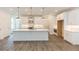 Modern kitchen with white cabinets, quartz countertops and island at 1442 Casteel Lake Ln # 277, Buford, GA 30518