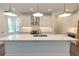 Modern kitchen with white cabinets, quartz countertops and island at 1442 Casteel Lake Ln # 277, Buford, GA 30518