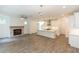 Spacious living room with fireplace flows into a modern white kitchen, perfect for entertaining at 1442 Casteel Lake Ln # 277, Buford, GA 30518