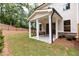 Covered patio with concrete flooring and grassy backyard at 1442 Casteel Lake Ln # 277, Buford, GA 30518