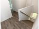 Modern staircase with hardwood flooring and white railing at 1442 Casteel Lake Ln # 277, Buford, GA 30518