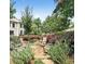 Stone patio with comfortable seating surrounded by lush landscaping and trees at 213 Knob Hills Cir, Decatur, GA 30030