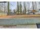 Large backyard with a retaining wall and mature trees at 1606 Fieldgreen Overlook, Stone Mountain, GA 30088