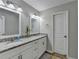 Bathroom with double sinks, granite countertop and white cabinets at 1606 Fieldgreen Overlook, Stone Mountain, GA 30088