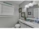 Small bathroom with granite countertop, white cabinets, and decorative accents at 1606 Fieldgreen Overlook, Stone Mountain, GA 30088