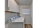 Bright laundry room with white cabinets and updated appliances at 1606 Fieldgreen Overlook, Stone Mountain, GA 30088