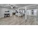 Open concept living room with wood-look floors and modern sectional at 1606 Fieldgreen Overlook, Stone Mountain, GA 30088