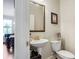 Small bathroom with pedestal sink, toilet and gold fixtures at 1567 Brunswick St, Lithia Springs, GA 30122
