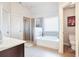 Bathroom with soaking tub, shower, and toilet at 1567 Brunswick St, Lithia Springs, GA 30122