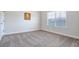 Simple bedroom with neutral walls and carpet at 1567 Brunswick St, Lithia Springs, GA 30122