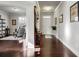 Bright hallway with hardwood floors, neutral paint, and tasteful decor leading to the front door and sitting room at 1567 Brunswick St, Lithia Springs, GA 30122