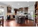 Spacious kitchen featuring stainless steel appliances, dark wood cabinets, and a granite-topped island with seating at 1567 Brunswick St, Lithia Springs, GA 30122