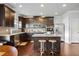 Modern kitchen featuring stainless steel appliances, dark wood cabinets, and a granite-topped island with bar stool seating at 1567 Brunswick St, Lithia Springs, GA 30122