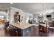 Open-concept living room featuring hardwood floors, neutral walls, and comfortable seating areas with classic furniture pieces at 1567 Brunswick St, Lithia Springs, GA 30122