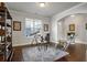 Cozy sitting room with a large window, comfortable seating, and unique decor on hardwood floors at 1567 Brunswick St, Lithia Springs, GA 30122