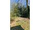 Wooden swing in a tree-filled backyard at 2105 Fellowship Rd, Tucker, GA 30084