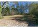 Large backyard with mature trees and stone pathway at 2105 Fellowship Rd, Tucker, GA 30084