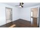 Bright bedroom with dark hardwood floors and ceiling fan at 2105 Fellowship Rd, Tucker, GA 30084