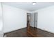 Well-lit bedroom with hardwood floors and a door to another room at 2105 Fellowship Rd, Tucker, GA 30084