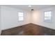Bright bedroom with hardwood floors and two windows at 2105 Fellowship Rd, Tucker, GA 30084