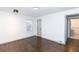 Well-lit bedroom with hardwood floors and access to bathroom at 2105 Fellowship Rd, Tucker, GA 30084