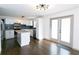 Modern kitchen with white cabinets, granite island, and dark tile backsplash at 2105 Fellowship Rd, Tucker, GA 30084