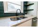 Double stainless steel sink with modern faucet and blue tile backsplash at 2105 Fellowship Rd, Tucker, GA 30084
