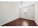 Simple bedroom with hardwood floors and window with blinds at 2144 Woodmarsh Cir, Auburn, GA 30011