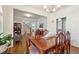 Open-concept dining room featuring hardwood floors, white trim and ample lighting at 4620 Hardwick Ct, Suwanee, GA 30024