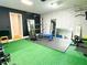 Well-equipped home gym featuring mirrors, weightlifting equipment, and turf flooring at 320 Kentshire, Lawrenceville, GA 30044