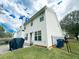 Rear view of a two-story house with white siding, patio, and fenced yard at 320 Kentshire, Lawrenceville, GA 30044